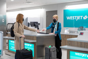 Traveller checks in to WestJet at the Fredericton International Airport