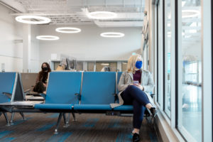 travellers in Fredericton International Airport wearing a mask