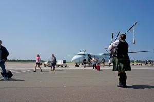 Bagpiper Megan Stewart serenades passengers arriving at the Fredericton International Airport on July 25