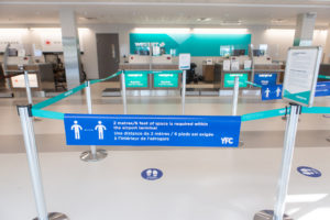 WestJet check-in counter at YFC with physical distancing signage