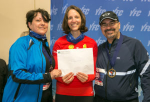 Corena Walby, YFC Runway Run Race Director, presents Celeste and Ahmet Tahan with the Perseverance Award.
