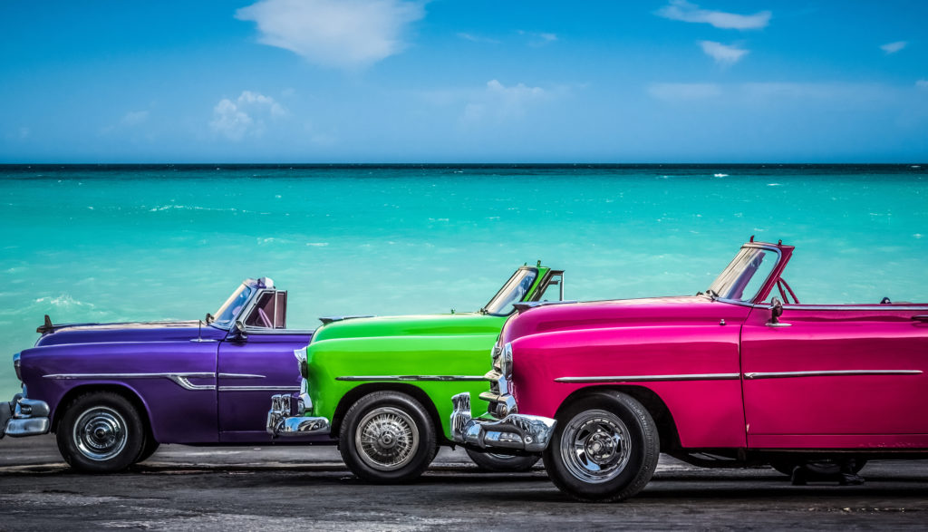 Vintage, colourful vehicles by the sea