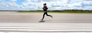 Runner racing a 5k on the runways of the Fredericton International Airport in the inaugural YFC Runway Run